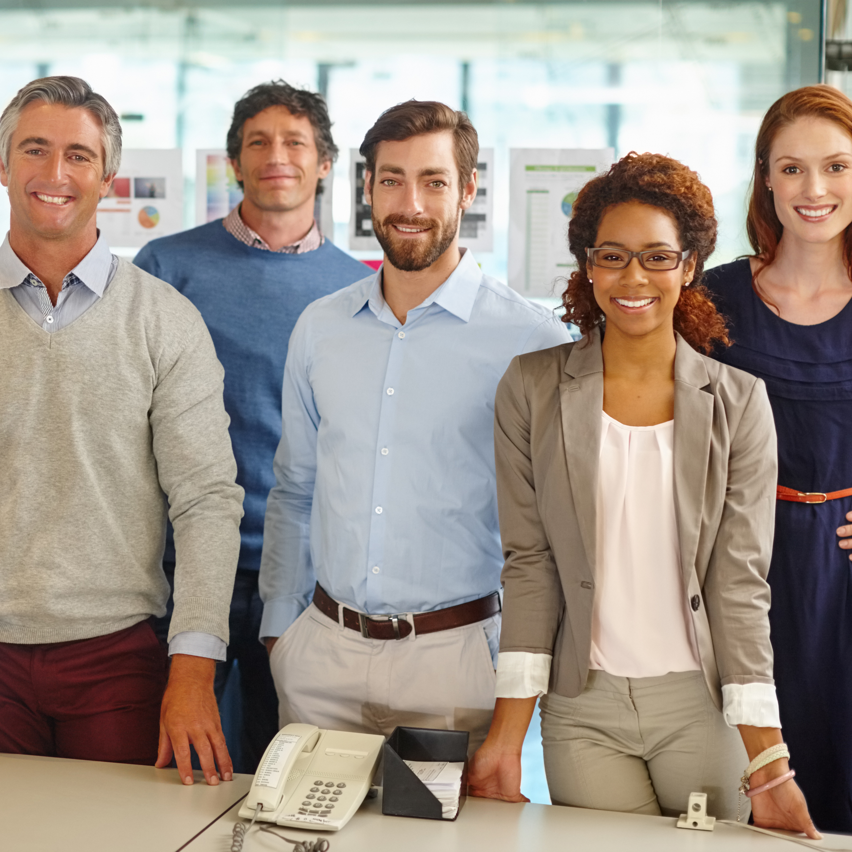 One team committed to the dream. Portrait of a diverse team of professionals working in an office.